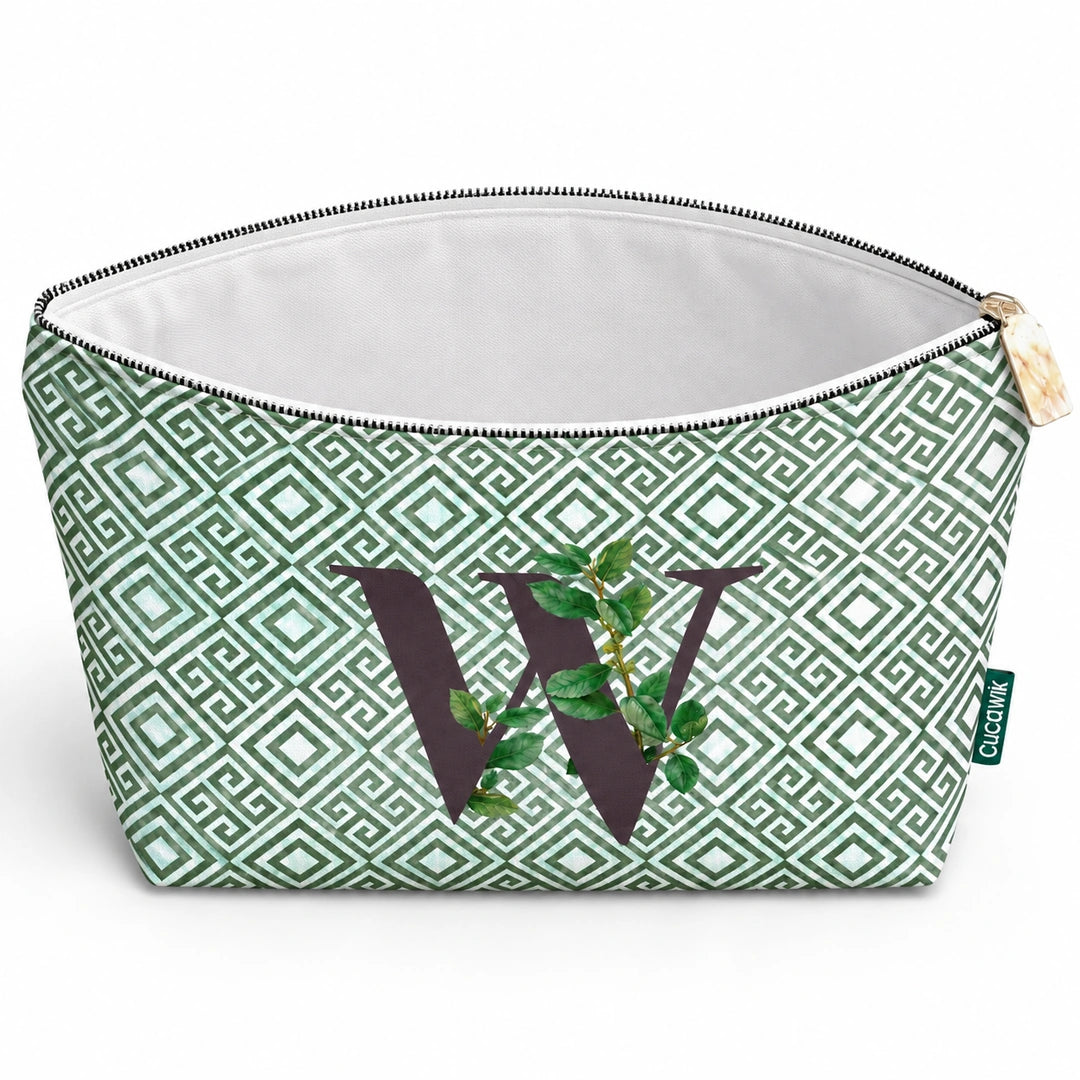 Bolsa Guta verde letra W aberta e vazia, com interior branco, sem forro e sem divisórias.